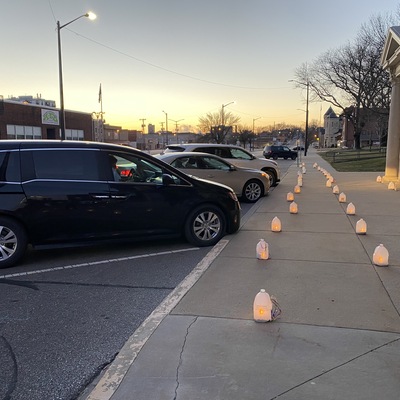 Luminaries honor our community and light up a cold Christmas Eve drive up caroling service at AUMC
