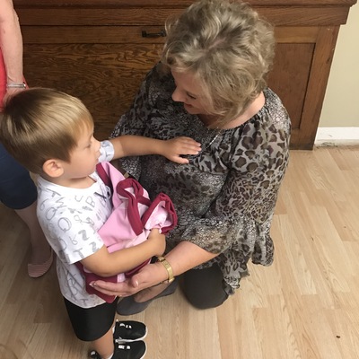 Pastor Cyd gets a thank you for the daycare blanket handmade by AUMC