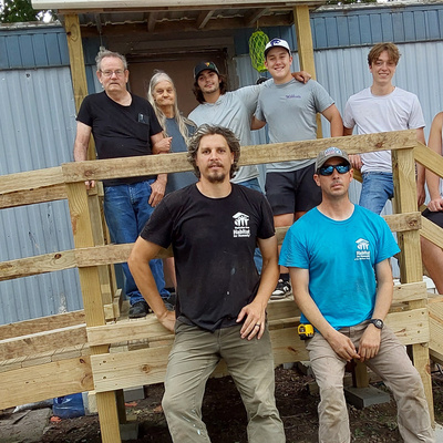 Consumers and builders from Habitat for Humanity & K-State stand on new ramp donated by 3Rivers.