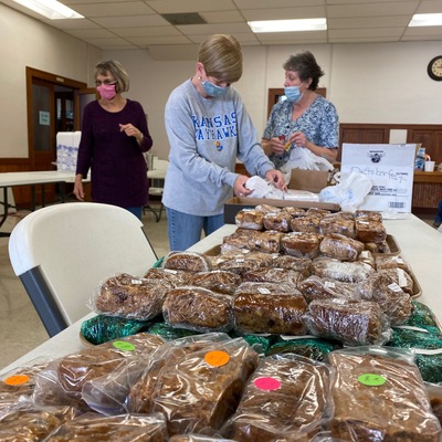 Volunteers prepare to serve up apple cake during drive-thru Oktoberfest (reimagined 2020).