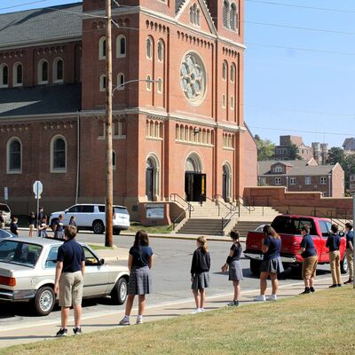 Praying outside of a parish funeral